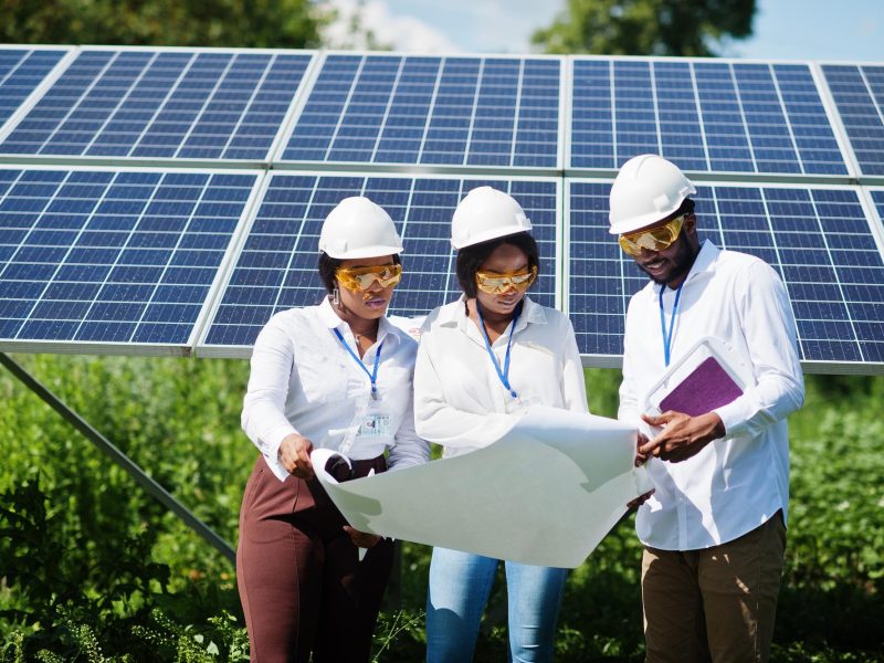 african-american-technician-checks-maintenance-solar-panels-group-three-black-engineers-meeting-solar-station